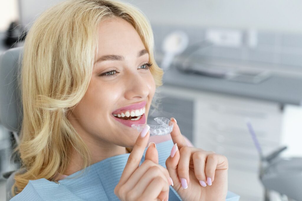 Woman holding clear aligners